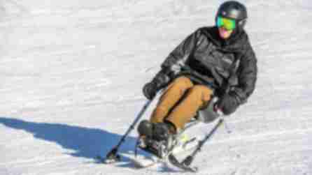 An adaptive skier in action on a snow-covered slope on Windham Mountain