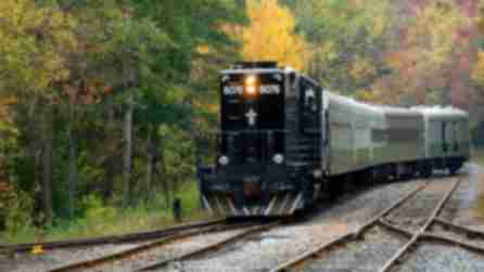 Adirondack Scenic Railroad in Old Forge, train on tracks surrounded by fall foliage