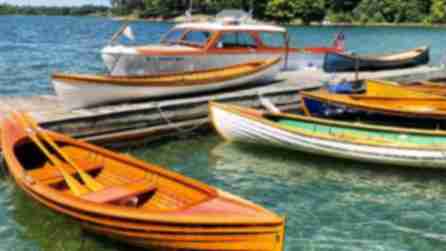 Antique boats on the water on a sunny day at the Antique Boat Museum in Clayton.