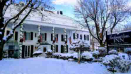 Exterior of the Beekman Arms and Delamater Inn covered in snow and decorated for the holidays