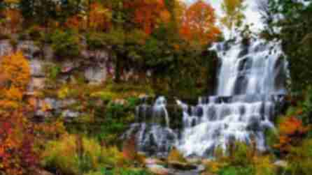 cascading waterfall surrounded by colorful fall foliage