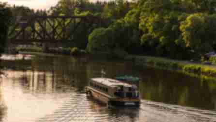 A boat sailing along the Erie Canal in Pittsford, NY