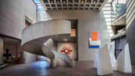 A spiral staircase and art inside the Everson Museum