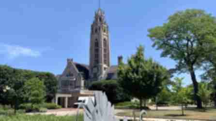 The main building and tower of the Memorial Art Gallery set against a blue sky