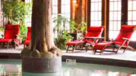 red deck chairs sat around a heated pool at mirror lake inn and spa