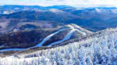 Snow-covered trees and mountain terrain from the top of Whiteface mountain in the Adirondacks